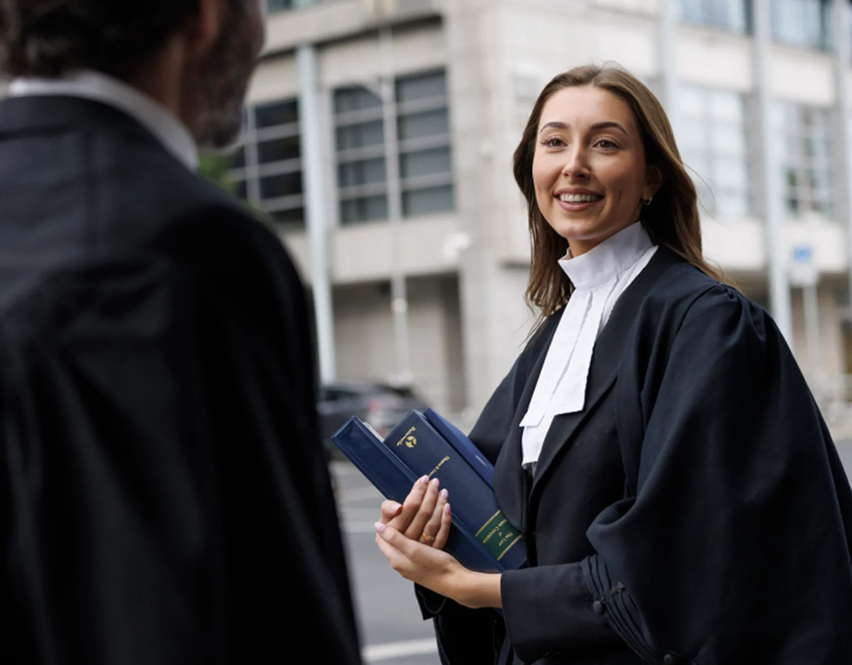 A barrister in robes outside court